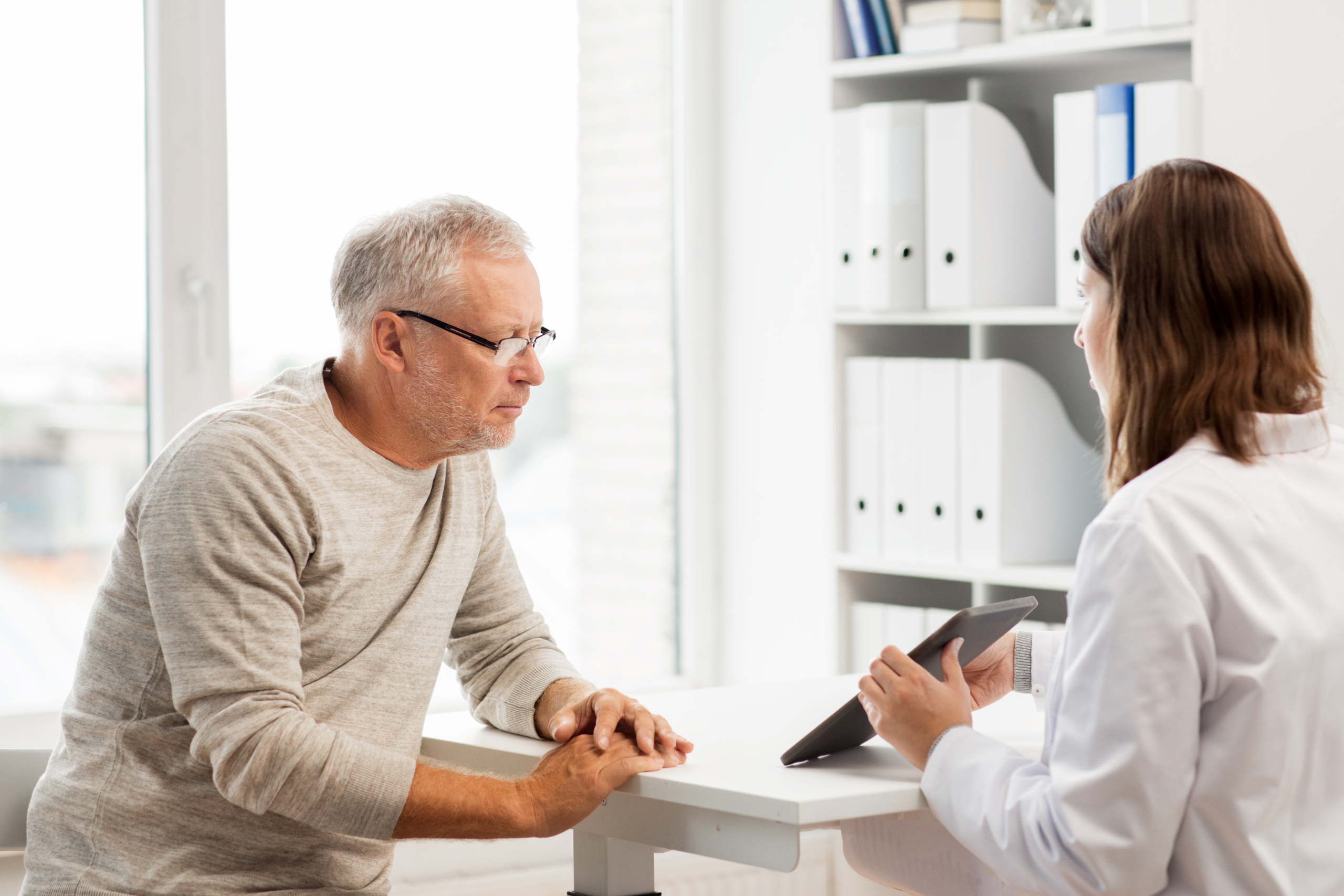 doctor explaining benefits to senior patient