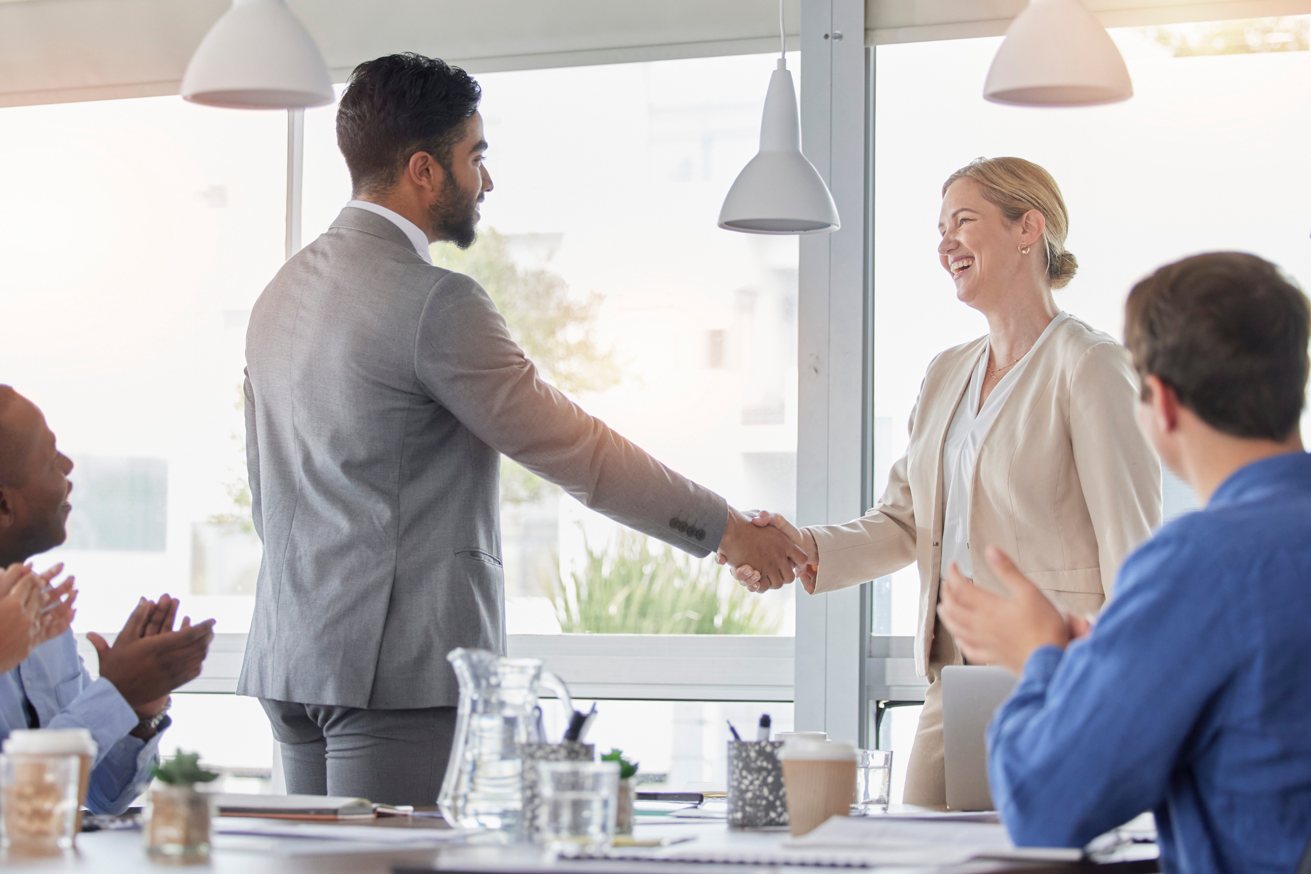 Man and woman in business meeting shaking hands
