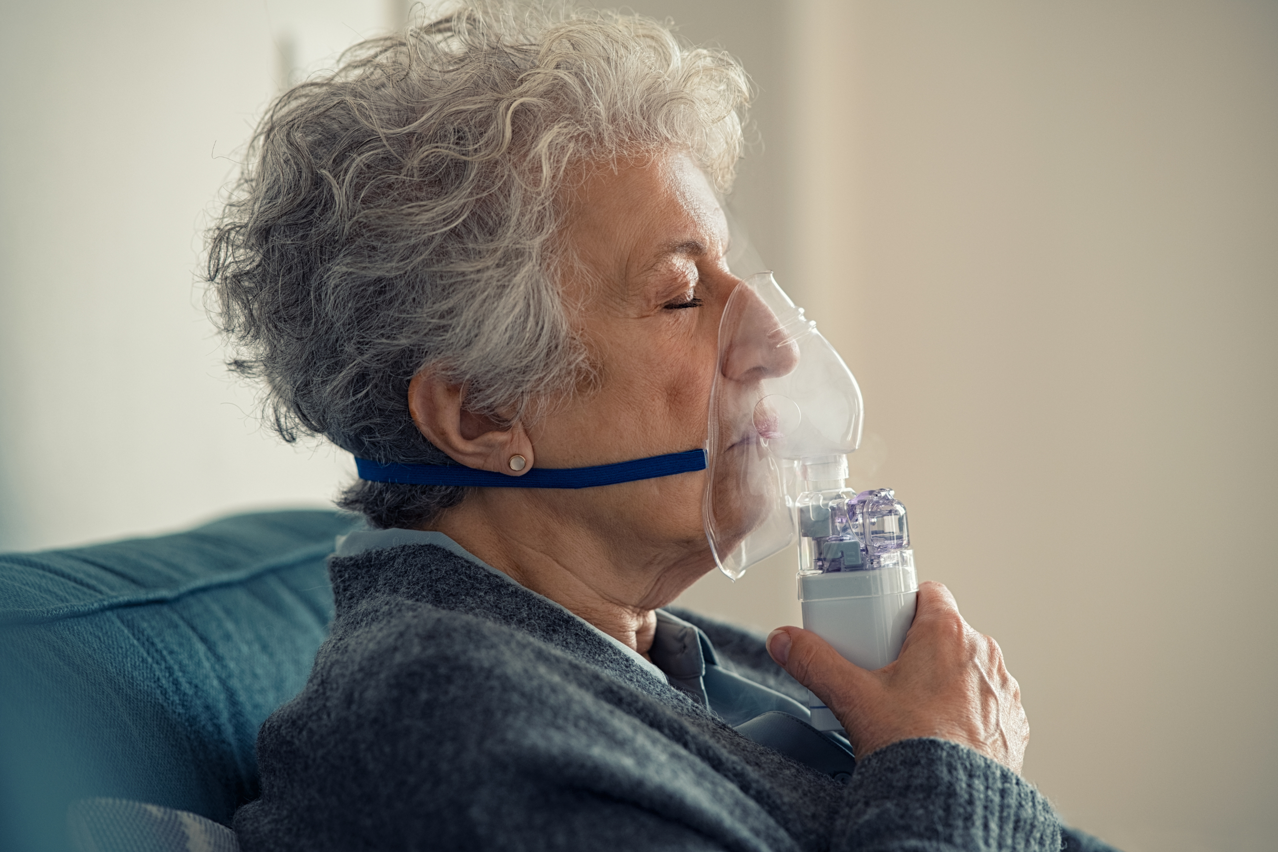 Senior woman using nebulizer