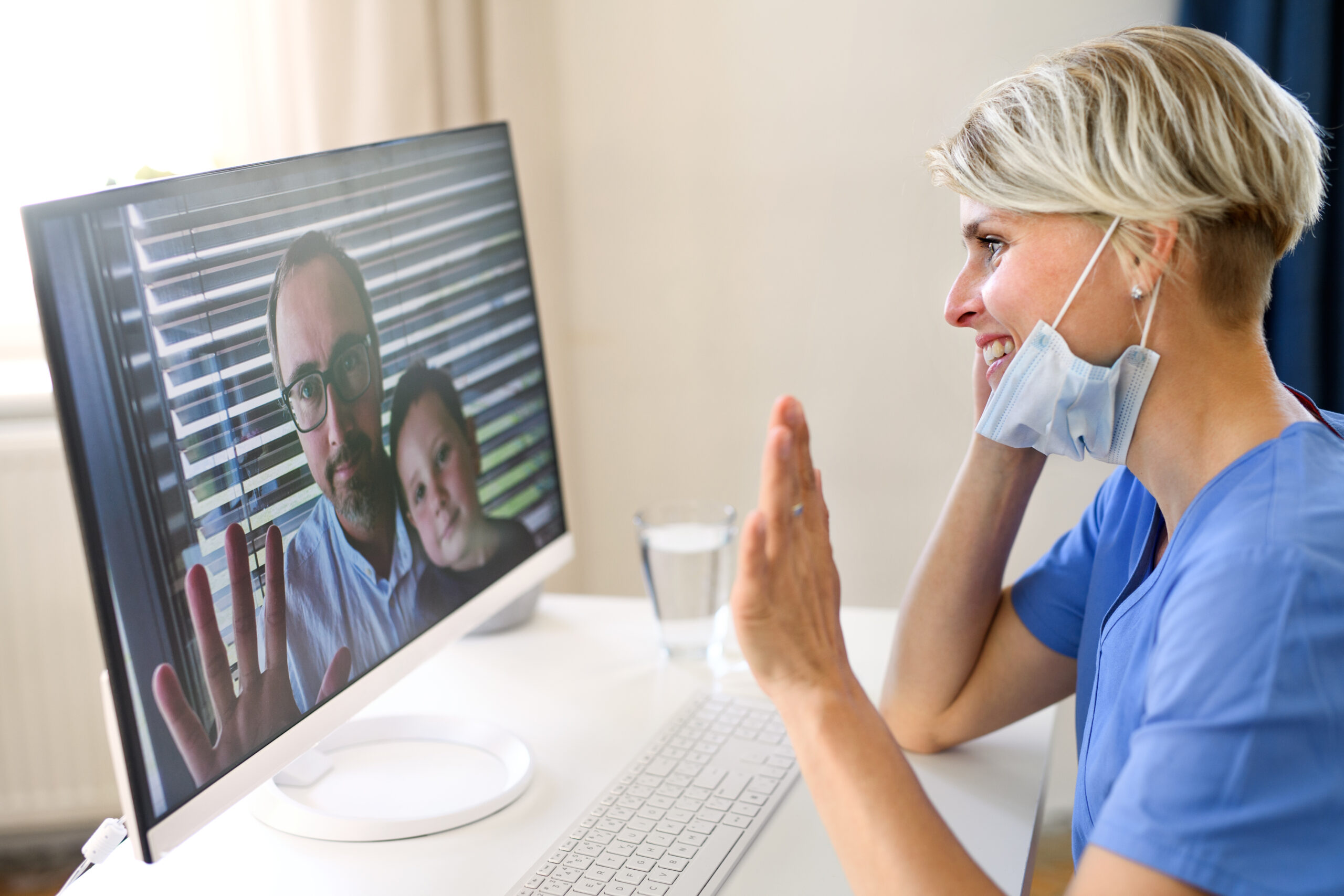 Woman doctor having video call with patients on laptop, online consultation concept.