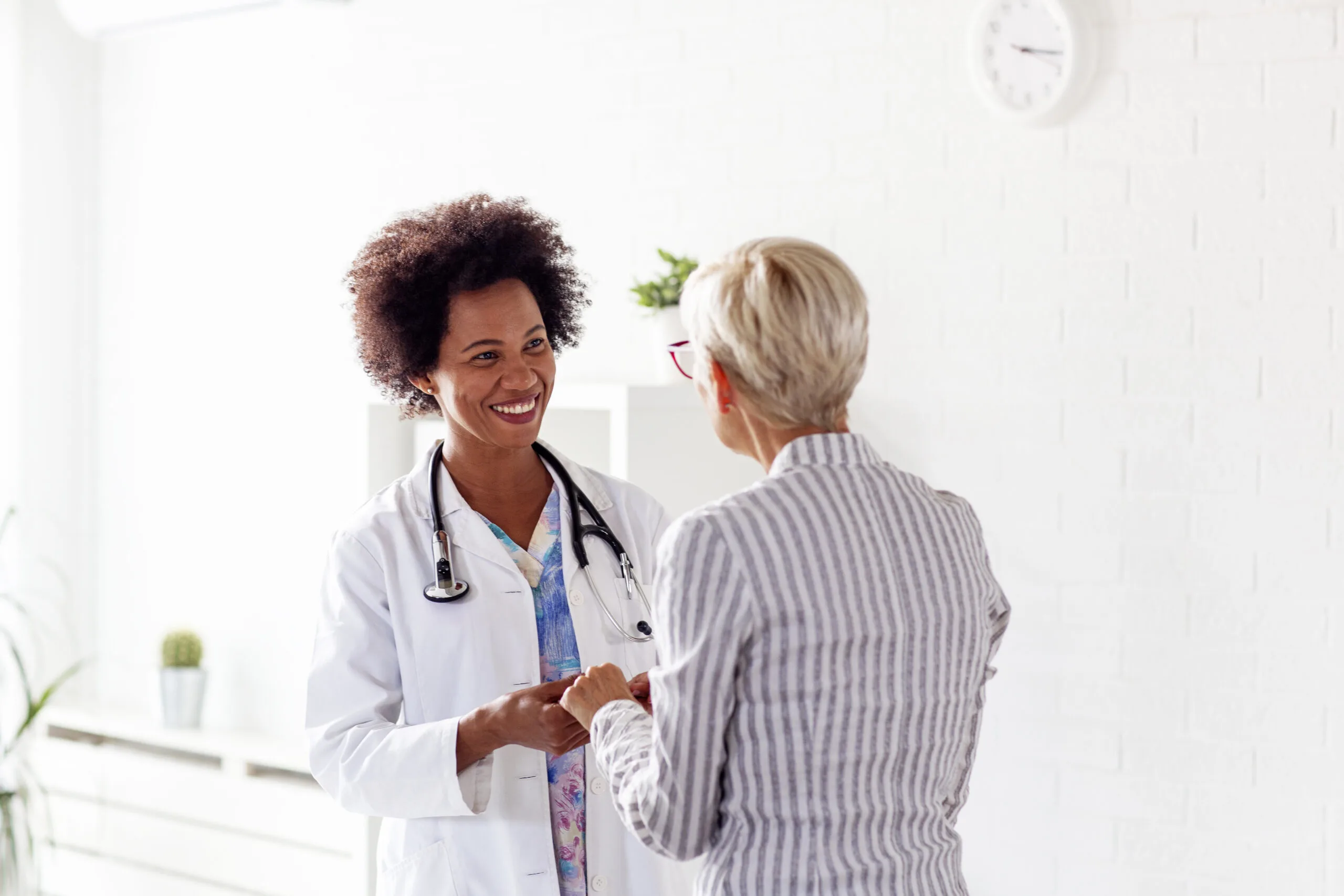 older woman in ambulance with her doctor on medical treatment