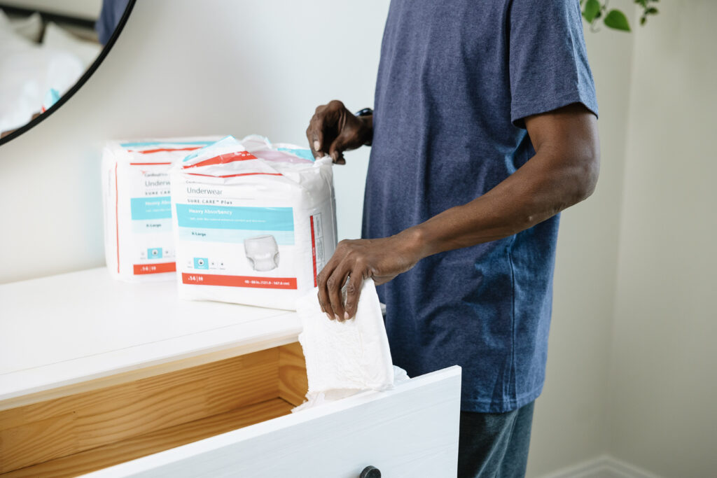 man stowing incontinence products