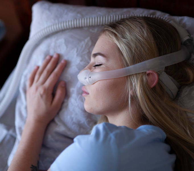 Women asleep with cpap mask