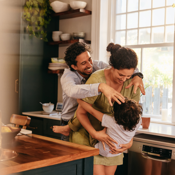 family embracing in the kitchen