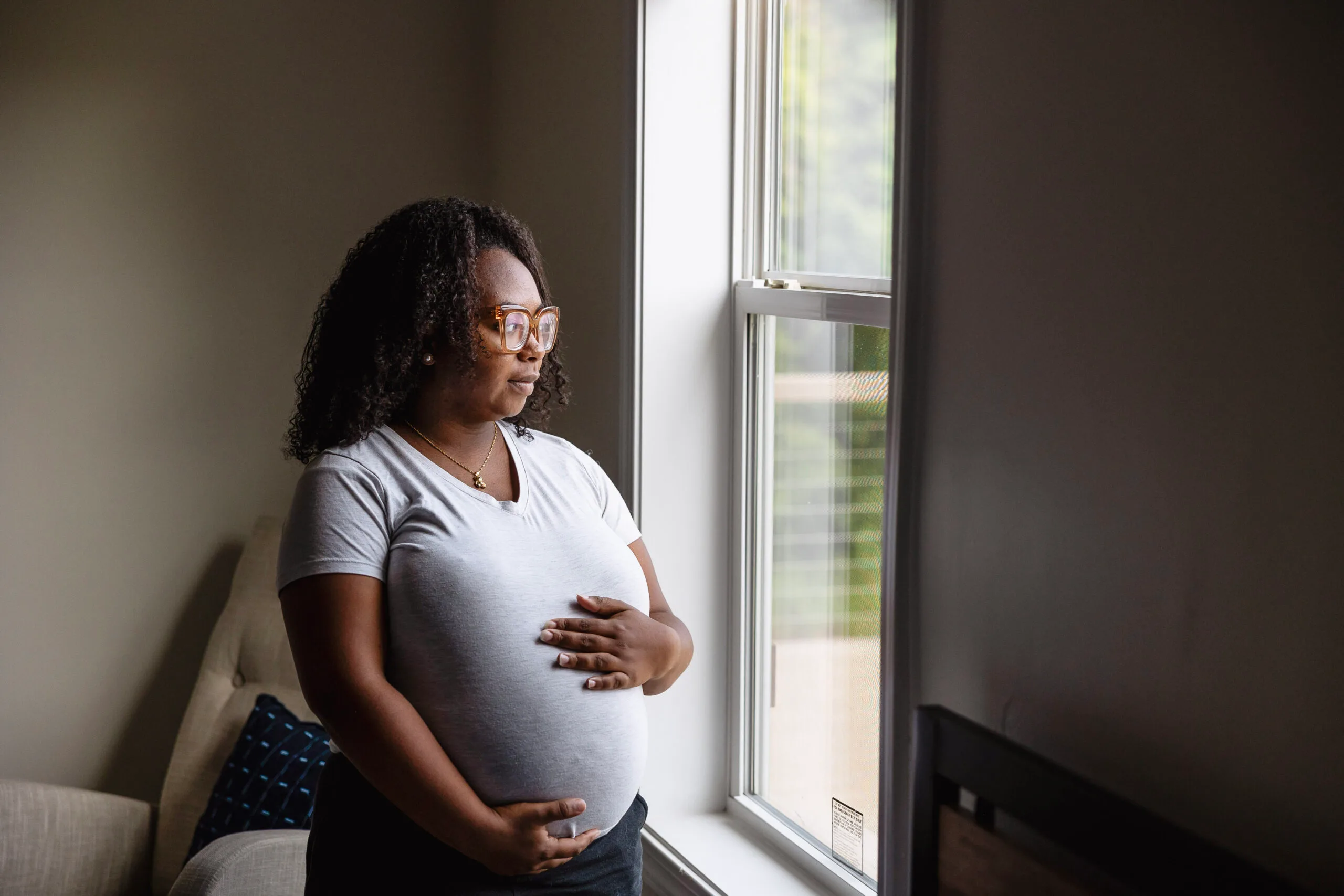 Pregnant women looking out a window