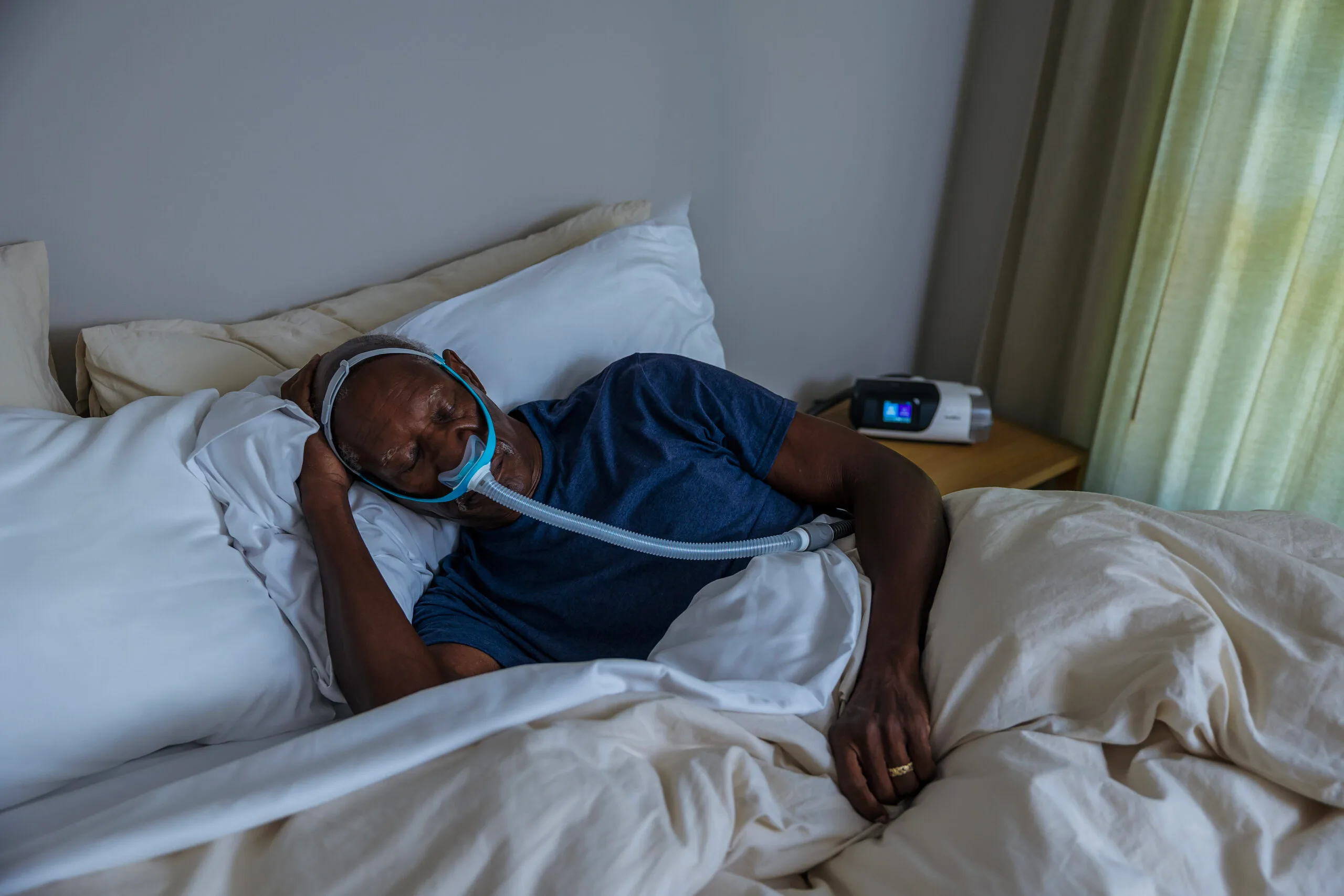 Man asleep with sleep apnea mask