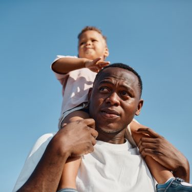 Dad carrying son